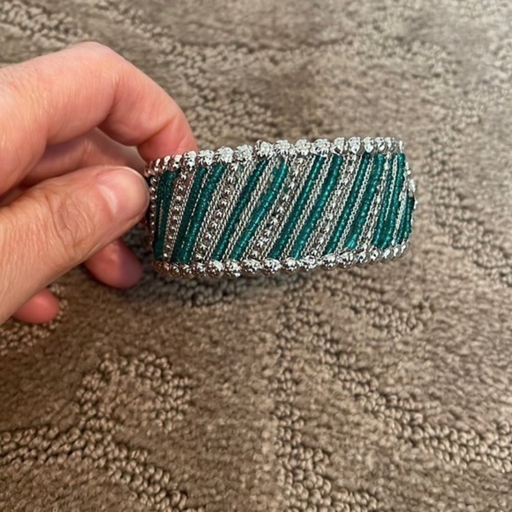Green bead and silver tone bracelet. Spring closure.